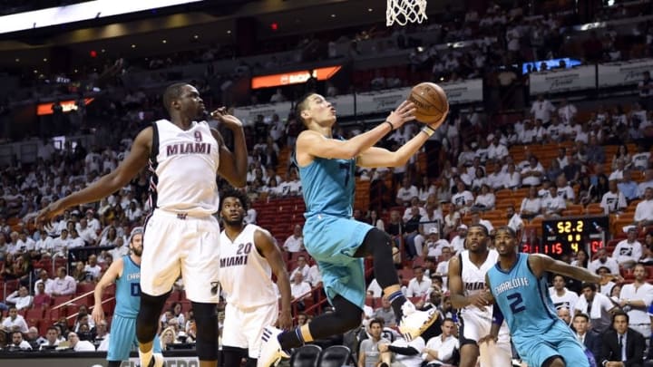 Apr 20, 2016; Miami, FL, USA; Charlotte Hornets guard Jeremy Lin (7) shoots the ball in front of Miami Heat forward Luol Deng (9) in game two of the first round of the NBA Playoffs during the fourth quarter at American Airlines Arena. The Heat won 115-103. Mandatory Credit: Steve Mitchell-USA TODAY Sports