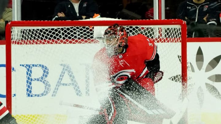 RALEIGH, NC - OCTOBER 29: Petr Mrazek #34 of the Carolina Hurricanes gets snowed in the crease during an NHL game against the Calgary Flames on October 29, 2019 at PNC Arena in Raleigh, North Carolina. (Photo by Gregg Forwerck/NHLI via Getty Images)