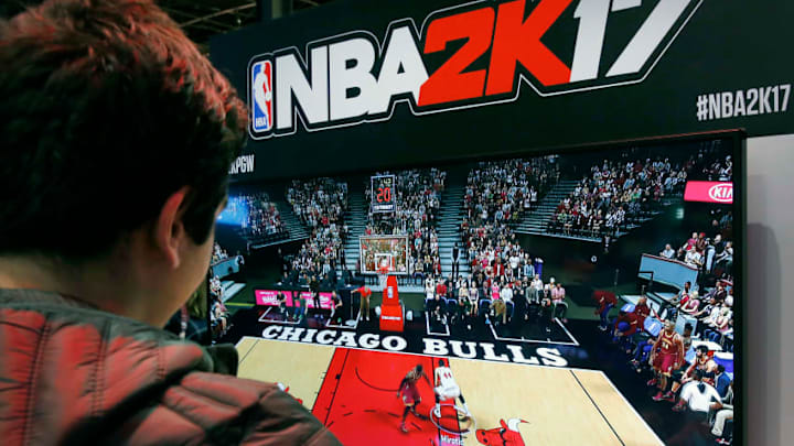 PARIS, FRANCE - OCTOBER 27: A visitor plays the video game 'NBA 2K 17' developed by Visual Concepts and published by 2K Sports on Sony PlayStation game console PS4 during the 'Paris Games Week'on October 27, 2016 in Paris, France. 'Paris Games Week' is an international trade fair for video games to be held from October 27 to October 31, 2016. (Photo by Chesnot/Getty Images)