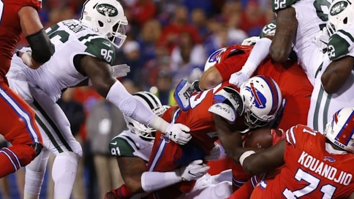 Sep 15, 2016; Orchard Park, NY, USA; Buffalo Bills running back LeSean McCoy (25) is tackled by New York Jets defensive end Sheldon Richardson (91) and defensive end Muhammad Wilkerson (96) during the second half at New Era Field. The Jets beat the Bills 37-31. Mandatory Credit: Kevin Hoffman-USA TODAY Sports