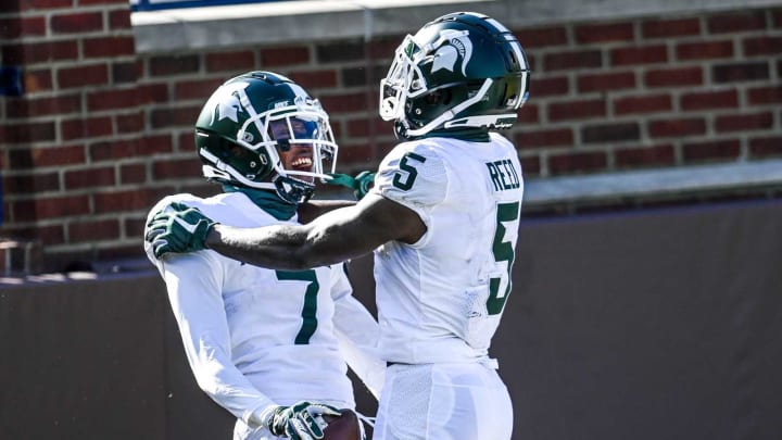 Michigan State’s Ricky White, left, celebrates his touchdown with teammate Jayden Reed against Michigan during the first quarter on Saturday, Oct. 31, 2020, at Michigan Stadium in Ann Arbor. 201031 Msu Um 048a