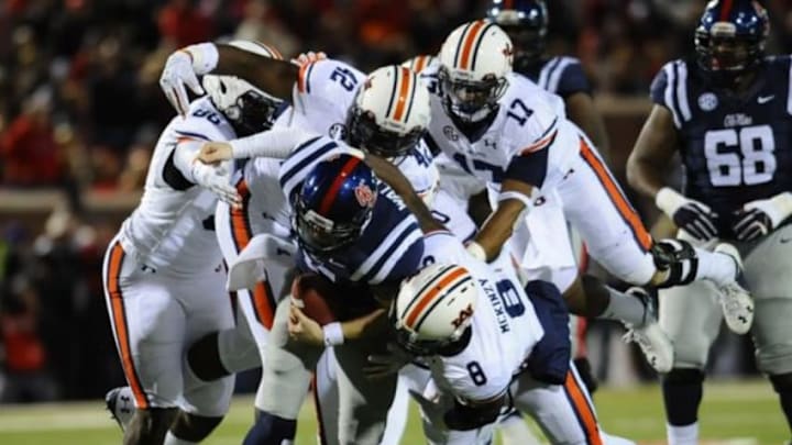 Nov 1, 2014; Oxford, MS, USA; Ole Miss Rebels quarterback Bo Wallace (14) is tackled by Auburn Tigers linebacker Cassanova McKinzy (8) during the second quarter at Vaught-Hemingway Stadium. Mandatory Credit: Shanna Lockwood-USA TODAY Sports Nov 1, 2014; Oxford, MS, USA; Ole Miss Rebels quarterback Bo Wallace (14) is tackled by Auburn Tigers linebacker Cassanova McKinzy (8) during the second quarter at Vaught-Hemingway Stadium. Mandatory Credit: Shanna Lockwood-USA TODAY Sports