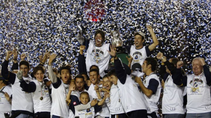MONTERREY, MEXICO: The players of Pumas, celebrate with trophy after the game the cup fnal of the tilt gains opening 2004, In Monterrey-Mexico, 12 December 2004. AFP PHOTO/Juan BARRETO (Photo credit should read JUAN BARRETO/AFP/Getty Images)