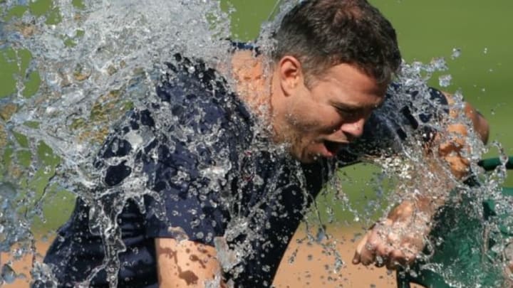 Aug 14, 2014; Chicago, IL, USA; Chicago Cubs vice president of baseball operations Theo Epstein is dunked with a bucket of water as part of the ice bucket challenge in awareness for ALS research after the game between the Cubs and Milwaukee Brewers at Wrigley Field. Mandatory Credit: Jerry Lai-USA TODAY Sports