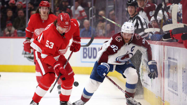 DETROIT, MICHIGAN - FEBRUARY 23: Moritz Seider #53 of the Detroit Red Wings battles for the puck against Gabriel Landeskog #92 of the Colorado Avalanche during the third period at Little Caesars Arena on February 23, 2022 in Detroit, Michigan. Colorado won the game 5-2. (Photo by Gregory Shamus/Getty Images)