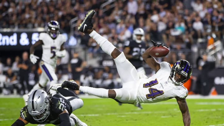 Sep 13, 2021; Paradise, Nevada, USA; Baltimore Ravens wide receiver Sammy Watkins (14) is upended by Las Vegas Raiders safety Tre'von Moehrig (25) in the second half during Monday Night Football at Allegiant Stadium. Mandatory Credit: Mark J. Rebilas-USA TODAY Sports