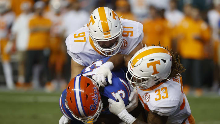 Sep 25, 2021; Gainesville, Florida, USA; Tennessee Volunteers linebacker Jeremy Banks (33) and defensive lineman Caleb Tremblay (97) tackles Florida Gators quarterback Emory Jones (5) during the first quarter at Ben Hill Griffin Stadium. Mandatory Credit: Kim Klement-USA TODAY Sports
