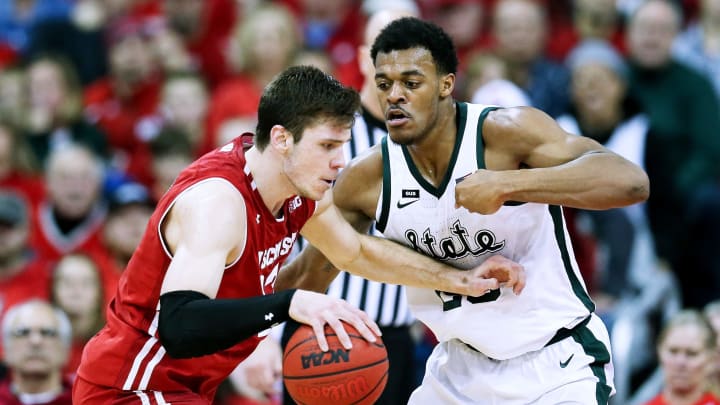 MADISON, WISCONSIN – FEBRUARY 12: Ethan Happ #22 of the Wisconsin Badgers dribbles the ball while being guarded by Xavier Tillman #23 of the Michigan State Spartans in the second half at the Kohl Center on February 12, 2019 in Madison, Wisconsin. (Photo by Dylan Buell/Getty Images)