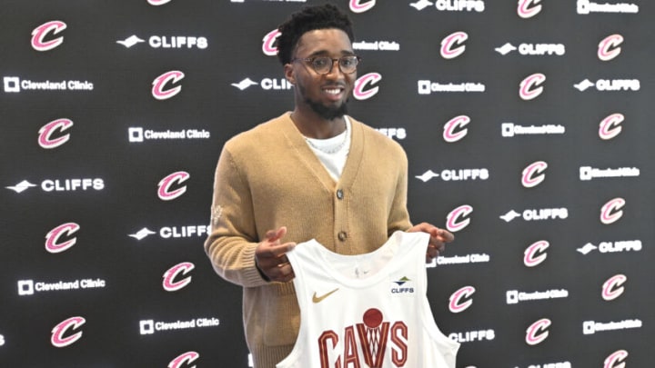 Sep 14, 2022; Cleveland, OH, USA; Cleveland Cavaliers guard Donovan Mitchell poses with his jersey during an introductory press conference at Rocket Mortgage FieldHouse. Mandatory Credit: David Richard-USA TODAY Sports