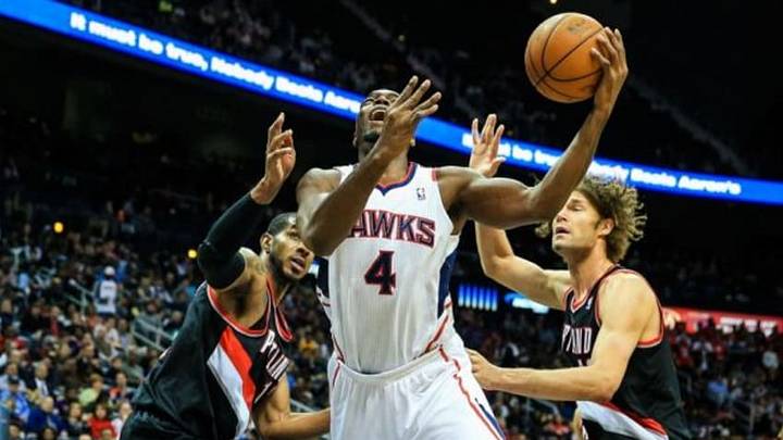 Mar 27, 2014; Atlanta, GA, USA; Atlanta Hawks forward Paul Millsap (4) shoots between Portland Trail Blazers center Robin Lopez (42) and forward LaMarcus Aldridge (12) in the second half at Philips Arena. The Portland Trail Blazers won 100-85. Mandatory Credit: Daniel Shirey-USA TODAY Sports Mar 27, 2014; Atlanta, GA, USA; Atlanta Hawks forward Paul Millsap (4) shoots between Portland Trail Blazers center Robin Lopez (42) and forward LaMarcus Aldridge (12) in the second half at Philips Arena. The Portland Trail Blazers won 100-85. Mandatory Credit: Daniel Shirey-USA TODAY Sports