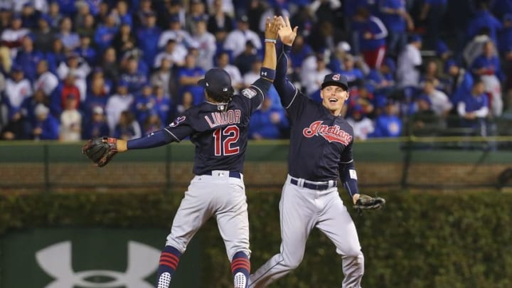 Oct 28, 2016; Chicago, IL, USA; Cleveland Indians shortstop Francisco Lindor (12) celebrates with left fielder Brandon Guyer (right) after game three of the 2016 World Series against the Chicago Cubs at Wrigley Field. The Indians defeated the Cubs 1-0. Mandatory Credit: Dennis Wierzbicki-USA TODAY Sports