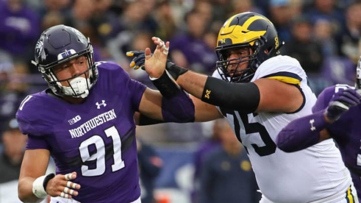 EVANSTON, IL - SEPTEMBER 29: Samdup Miller #91 of the Northwestern Wildcats rushes against Jon Runyan #75 of the Michigan Wolverines at Ryan Field on September 29, 2018 in Evanston, Illinois. Michigan defeated Northwestern 20-17. (Photo by Jonathan Daniel/Getty Images)