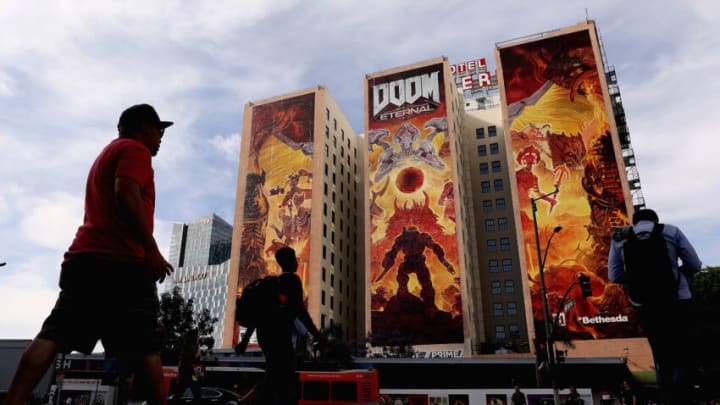 LOS ANGELES, CALIFORNIA - JUNE 10: Game enthusiasts and industry personnel walk past a 'Doom Eternal' ad ahead of the E3 Video Game Convention at the Los Angeles Convention Center on June 10, 2019 in Los Angeles, California. The E3 Game Conference begins on Tuesday June 11. (Photo by Christian Petersen/Getty Images)