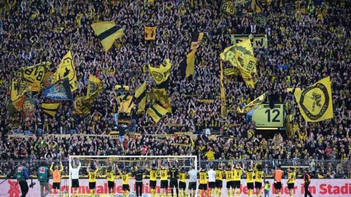 Borussia Dortmund players celebrate their win over Wolfsburg with the fans (Photo by INA FASSBENDER/AFP via Getty Images)