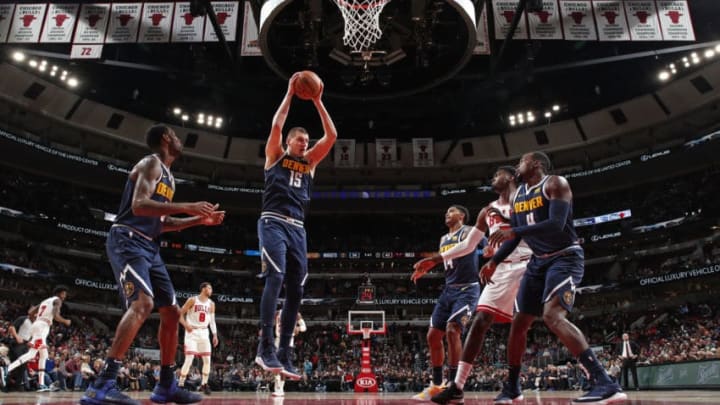 CHICAGO, IL - OCTOBER 12: Nikola Jokic #15 of the Denver Nuggets grabs a rebound against the Chicago Bulls during a pre-season game on October 12, 2018 at the United Center in Chicago, Illinois. NOTE TO USER: User expressly acknowledges and agrees that, by downloading and or using this Photograph, user is consenting to the terms and conditions of the Getty Images License Agreement. Mandatory Copyright Notice: Copyright 2018 NBAE (Photo by Jeff Haynes/NBAE via Getty Images)