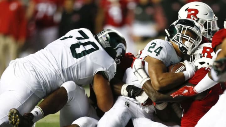 PISCATAWAY, NJ - NOVEMBER 25: Gerald Holmes #24 of the Michigan State Spartans tries to make yards against the Rutgers Scarlet Knights during their game on November 25, 2017 in Piscataway, New Jersey. (Photo by Jeff Zelevansky/Getty Images)