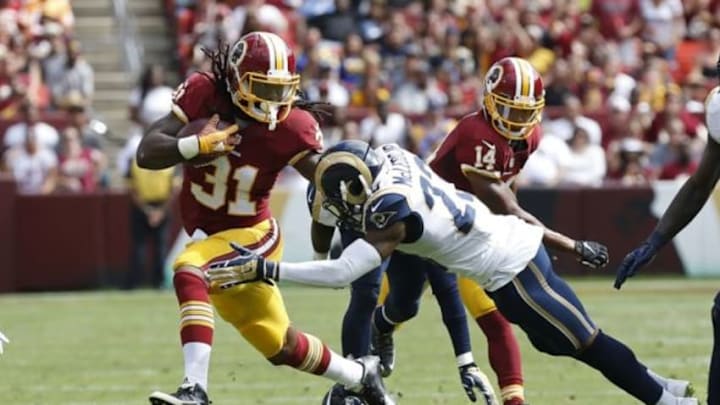 Sep 20, 2015; Landover, MD, USA; Washington Redskins running back Matt Jones (31) carries the ball as St. Louis Rams free safety Rodney McLeod (23) attempts the tackle in the second quarter at FedEx Field. Mandatory Credit: Geoff Burke-USA TODAY Sports