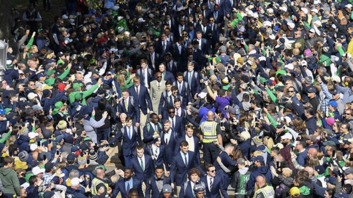 SOUTH BEND, IN - OCTOBER 13: Players of the Notre Dame Fighting Irish football team are greeted by fans entering the stadium prior to the game against the Pittsburgh Panthers at Notre Dame Stadium on October 13, 2018 in South Bend, Indiana. (Photo by Quinn Harris/Getty Images)