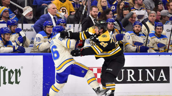 Apr 19, 2022; St. Louis, Missouri, USA; Boston Bruins center Marc McLaughlin (26) checks St. Louis Blues left wing Nathan Walker (26) during the first period at Enterprise Center. Mandatory Credit: Jeff Curry-USA TODAY Sports