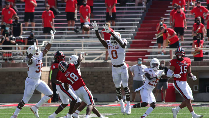 Sep 26, 2020; Lubbock, Texas, USA; Texas Tech Red Raiders wide receiver Myles Price (18) throws a pass against Texas Longhorns defensive lineman DeMarvion Overshown (0) in the first half at Jones AT&T Stadium. Mandatory Credit: Michael C. Johnson-USA TODAY Sports
