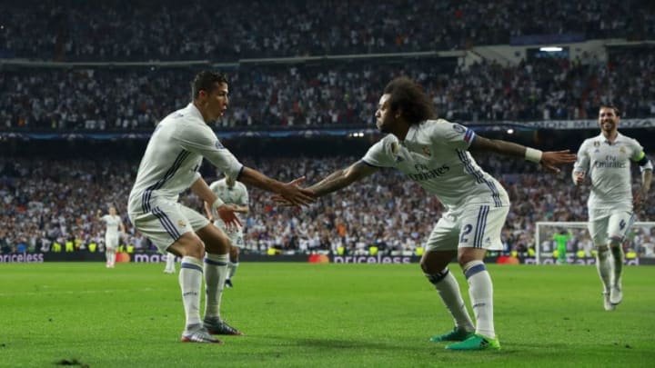 MADRID, SPAIN - APRIL 18: Cristiano Ronaldo (L) of Real Madrid CF celebrates scoring their third goal with teammate Marcelo (R) during the UEFA Champions League Quarter Final second leg match between Real Madrid CF and FC Bayern Muenchen at Estadio Santiago Bernabeu on April 18, 2017 in Madrid, Spain. (Photo by Gonzalo Arroyo Moreno/Getty Images)