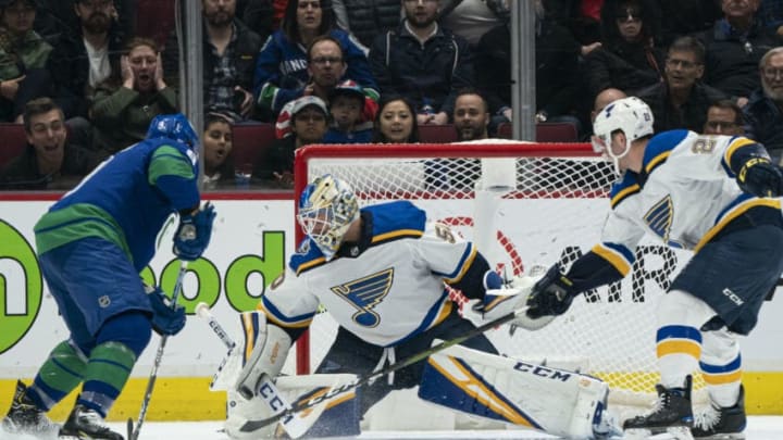 VANCOUVER, BC - NOVEMBER 05: Goalie Jordan Binnington #50 of the St. Louis Blues stops J.T. Miller #9 of the Vancouver Canucks in close at Rogers Arena on November 5, 2019 in Vancouver, Canada. Vince Dunn #29 of the St. Louis Blues tries to help defend on the play. (Photo by Rich Lam/Getty Images)