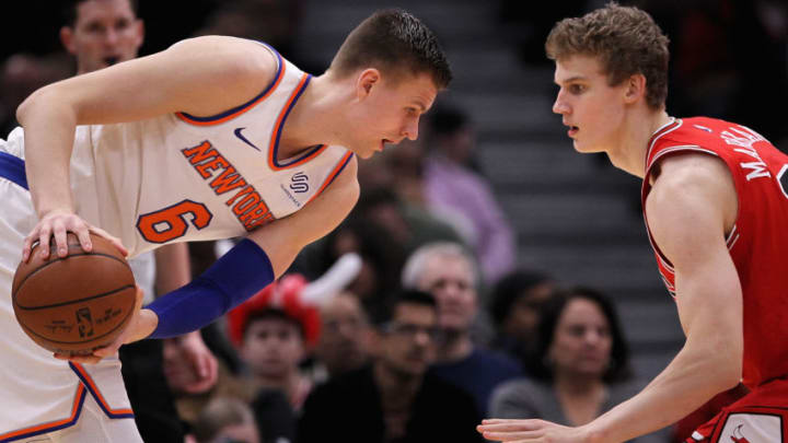 CHICAGO, IL - DECEMBER 09: Kristaps Porzingis #6 of the New York Knicks handles the ball while being guarded by Lauri Markkanen #24 of the Chicago Bulls in the fourth quarter at the United Center on December 9, 2017 in Chicago, Illinois. (Photo by Dylan Buell/Getty Images)