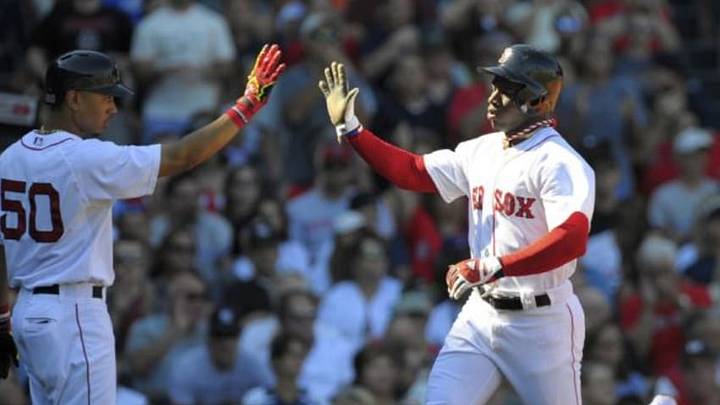 Sep 27, 2014; Boston, MA, USA; Boston Red Sox second baseman Mookie Betts (50) high fives center fielder Rusney Castillo (38) after scoring a run during the second inning against the New York Yankees at Fenway Park. Mandatory Credit: Bob DeChiara-USA TODAY Sports