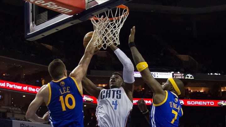 Dec 9, 2013; Charlotte, NC, USA; Charlotte Bobcats power forward Jeff Adrien (4) goes up for a shot between Golden State Warriors power forward David Lee (10) and Jermaine O
