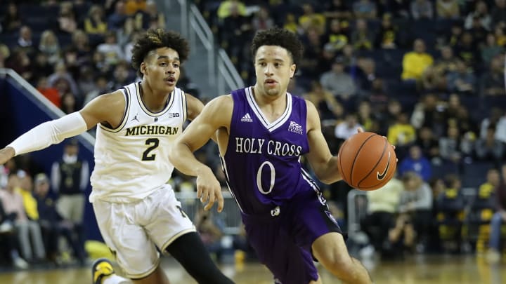 ANN ARBOR, MI – NOVEMBER 10: Caleb Green #0 of the Holy Cross Crusaders drives the ball to the basket as Jordan Poole #2 of the Michigan Wolverines defends during the second half of the game at Crisler Center on November 10, 2018 in Ann Arbor, Michigan. Michigan defeated Holy Cross Crusaders 56-37. (Photo by Leon Halip/Getty Images)