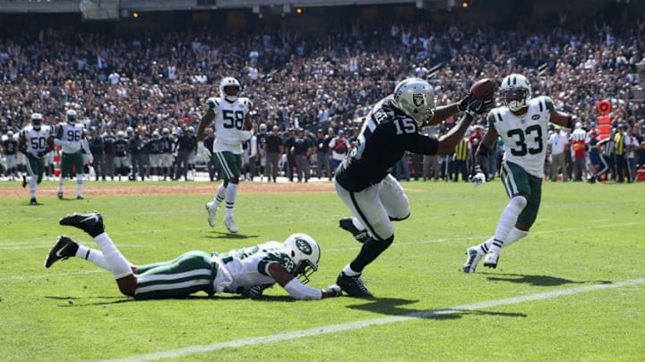 OAKLAND, CA - SEPTEMBER 17: Michael Crabtree #15 of the Oakland Raiders gets past Juston Burris #32 and Jamal Adams #33 of the New York Jets to score a touchdown at Oakland-Alameda County Coliseum on September 17, 2017 in Oakland, California. (Photo by Ezra Shaw/Getty Images)