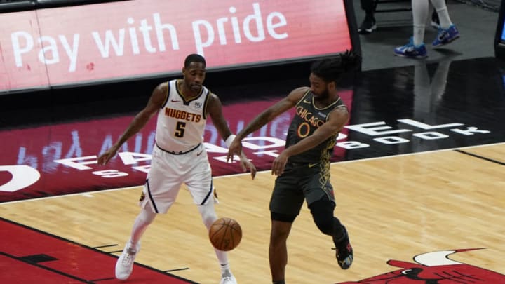 Mar 1, 2021; Chicago, Illinois, USA; Chicago Bulls guard Coby White (0) breaks up a pass on Denver Nuggets forward Will Barton (5) during the first quarter at the United Center. Mandatory Credit: Mike Dinovo-USA TODAY Sports