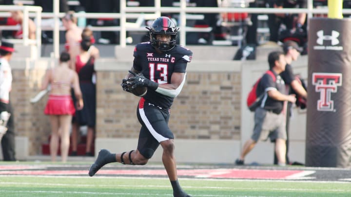 Sep 11, 2021; Lubbock, Texas, USA; Texas Tech Red Raiders wide receiver Erik Ezukanma (13) rushes after catching a pass in the first half in the game against the Stephen F. Austin Lumberjacks at Jones AT&T Stadium. Mandatory Credit: Michael C. Johnson-USA TODAY Sports