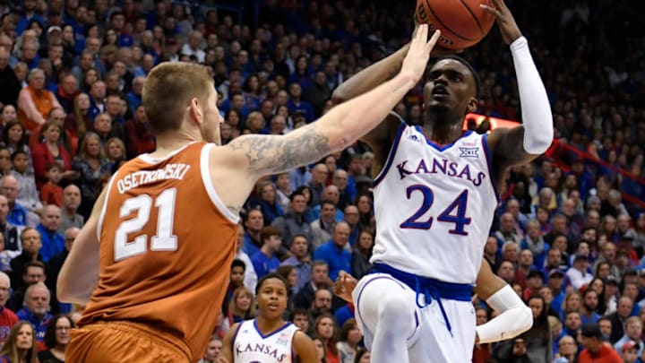 LAWRENCE, KANSAS - JANUARY 14: Lagerald Vick #24 of the Kansas Jayhawks lays the ball up against Dylan Osetkowski #21 of the Texas Longhorns in the first half at Allen Fieldhouse on January 14, 2019 in Lawrence, Kansas. (Photo by Ed Zurga/Getty Images)