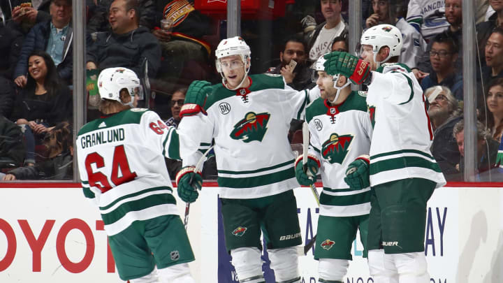 VANCOUVER, BC - DECEMBER 4: Jason Zucker #16 of the Minnesota Wild is congratulated by teammates Mikael Granlund #64, Charlie Coyle #3 and Eric Staal #12 after scoring during their NHL game against the Vancouver Canucks at Rogers Arena December 4, 2018 in Vancouver, British Columbia, Canada. The Wild won 3-2. (Photo by Jeff Vinnick/NHLI via Getty Images)