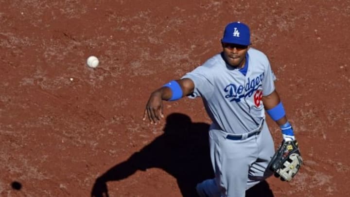 Aug 31, 2014; San Diego, CA, USA; Los Angeles Dodgers right fielder Yasiel Puig (66) tosses a ball into the stands after the fifth inning against the San Diego Padres at Petco Park. Mandatory Credit: Jake Roth-USA TODAY Sports