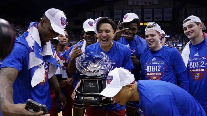 LAWRENCE, KANSAS – FEBRUARY 28: Members of the Kansas Jayhawks celebrate with the Big 12 conference trophy after their 67-63 win over Texas Tech Red Raiders at Allen Fieldhouse on February 28, 2023 in Lawrence, Kansas. (Photo by Ed Zurga/Getty Images)