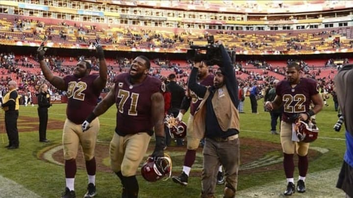 Nov 3, 2013; Landover, MD, USA; Washington Redskins tackle Trent Williams (71) and defensive end Chris Baker (92) celebrate as they walk off the field after the game against the San Diego Chargers at FedEx Field. The Redskins defeated the Chargers 30-24. Mandatory Credit: Tommy Gilligan-USA TODAY Sports