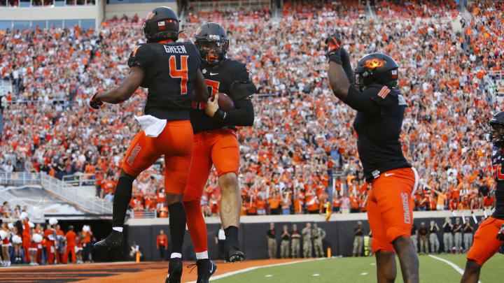 STILLWATER, OK – SEPTEMBER 28: Defensive end Brock Martin #40 of the Oklahoma State Cowboys celebrates his fumble recovery with cornerback A.J. Green #4 and linebacker Amen Ogbongbemiga #11 against the Kansas State Cowboys in the first quarter on September 28, 2019 at Boone Pickens Stadium in Stillwater, Oklahoma. (Photo by Brian Bahr/Getty Images)