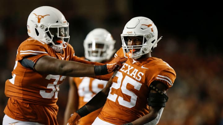 AUSTIN, TX - NOVEMBER 17: Malcolm Roach #32 of the Texas Longhorns congratulates B.J. Foster #25 after a sack in the fourth quarter against the Iowa State Cyclones at Darrell K Royal-Texas Memorial Stadium on November 17, 2018 in Austin, Texas. (Photo by Tim Warner/Getty Images)