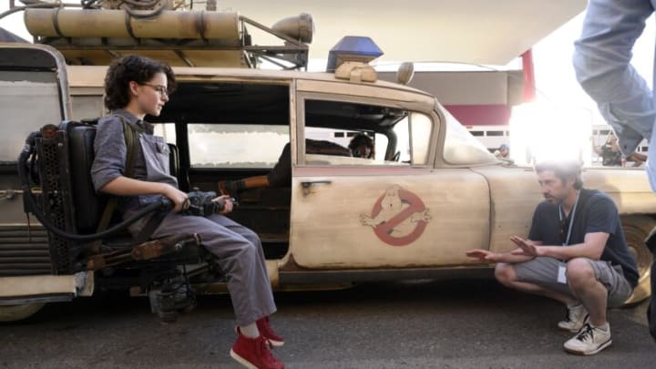 Director Jason Reitman with Mckenna Grace in the new Ecto-1 jumpseat on the set of GHOSTBUSTERS: AFTERLIFE.