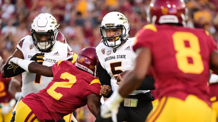 LOS ANGELES, CA - OCTOBER 01: Quarterback Manny Wilkins #5 of the Arizona State Sun Devils scrambles as he is contained by defensive back Adoree' Jackson #2 and defensive back Iman Marshall #8 of the USC Trojans during the first quarter at Los Angeles Coliseum on October 1, 2016 in Los Angeles, California. (Photo by Harry How/Getty Images)