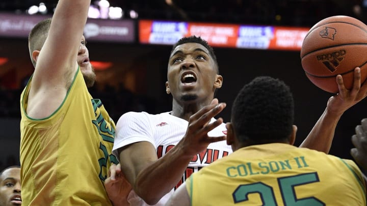 Mar 4, 2017; Louisville, KY, USA; Louisville Cardinals guard Donovan Mitchell (45) shoots the ball in front of Notre Dame Fighting Irish forward Martinas Geben (23) during the second half at KFC Yum! Center. Louisville defeated Notre Dame 71-64. Mandatory Credit: Jamie Rhodes-USA TODAY Sports