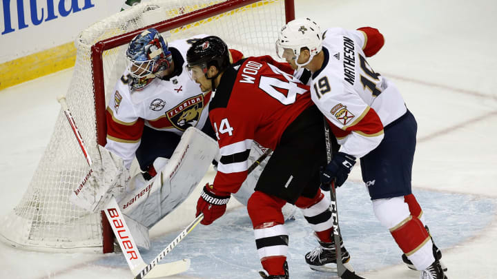 NEWARK, NJ – OCTOBER 27: Goaltender James Reimer #34 and teammate Michael Matheson #19 of the Florida Panthers defend the net against Miles Wood #44 of the New Jersey Devils at the Prudential Center on October 27, 2018 in Newark, New Jersey. (Photo by Eliot J. Schechter/NHLI via Getty Images)