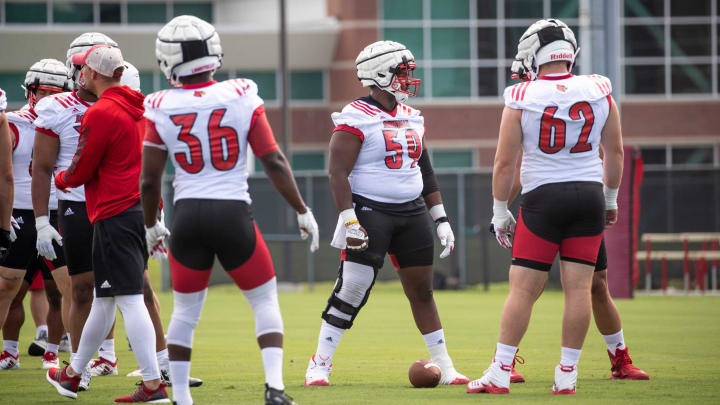Lining up at center, offensive lineman T.J. McCoy (59) snaps the ball during Louisville football’s first practice of the season, Sunday, Aug. 4, 2019 in Louisville Ky.0804 Ulfbopenpracticemh0002
