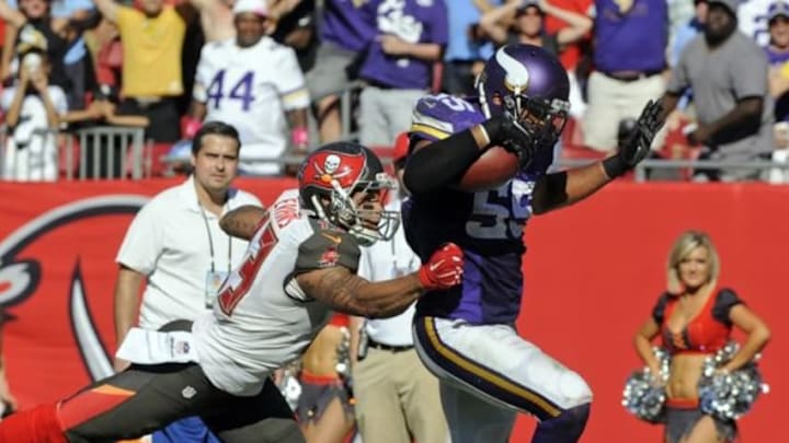 Oct 26, 2014; Tampa, FL, USA; Minnesota Vikings outside linebacker Anthony Barr (55) breaks the tackle of Tampa Bay Buccaneers wide receiver Mike Evans (13) for a 27-yard fumble recovery for a touchdown to win the game as the Vikings beat the Tampa Bay Buccaneers 19-13 in overtime at Raymond James Stadium. Mandatory Credit: David Manning-USA TODAY Sports