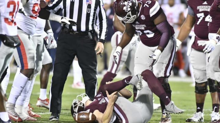 Nov 23, 2017; Starkville, MS, USA; (Editors note: Graphic injury) Mississippi State Bulldogs offensive lineman Darryl Williams (73) looks on as quarterback Nick Fitzgerald (7) reacts after being injured during the first quarter of the game against the Mississippi Rebels at Davis Wade Stadium. Mandatory Credit: Matt Bush-USA TODAY Sports