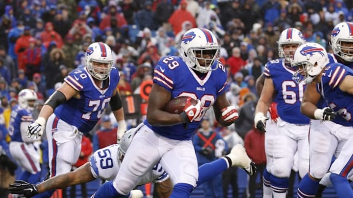 Dec 27, 2015; Orchard Park, NY, USA; Buffalo Bills running back Karlos Williams (29) rushes with the football defended by Dallas Cowboys middle linebacker Anthony Hitchens (59) during the second half at Ralph Wilson Stadium. The Bills defeat Cowboys 16-6. Mandatory Credit: Kevin Hoffman-USA TODAY Sports