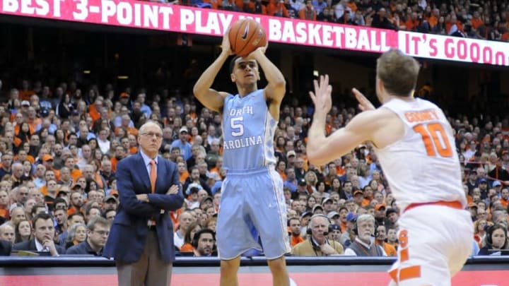 Jan 9, 2016; Syracuse, NY, USA; North Carolina Tar Heels guard Marcus Paige (5) takes a jump shot as Syracuse Orange head coach Jim Boeheim looks on during the first half of a game at the Carrier Dome. North Carolina won 84-73. Mandatory Credit: Mark Konezny-USA TODAY Sports