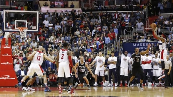 Nov 4, 2015; Washington, DC, USA; Washington Wizards guard Bradley Beal (3) makes the game-winning three-point basket over San Antonio Spurs forward LaMarcus Aldridge (12) in the final second of the fourth quarter at Verizon Center. The Wizards won 102-99. Mandatory Credit: Geoff Burke-USA TODAY Sports